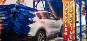 Car goes through car wash tunnel and gets hot wax|